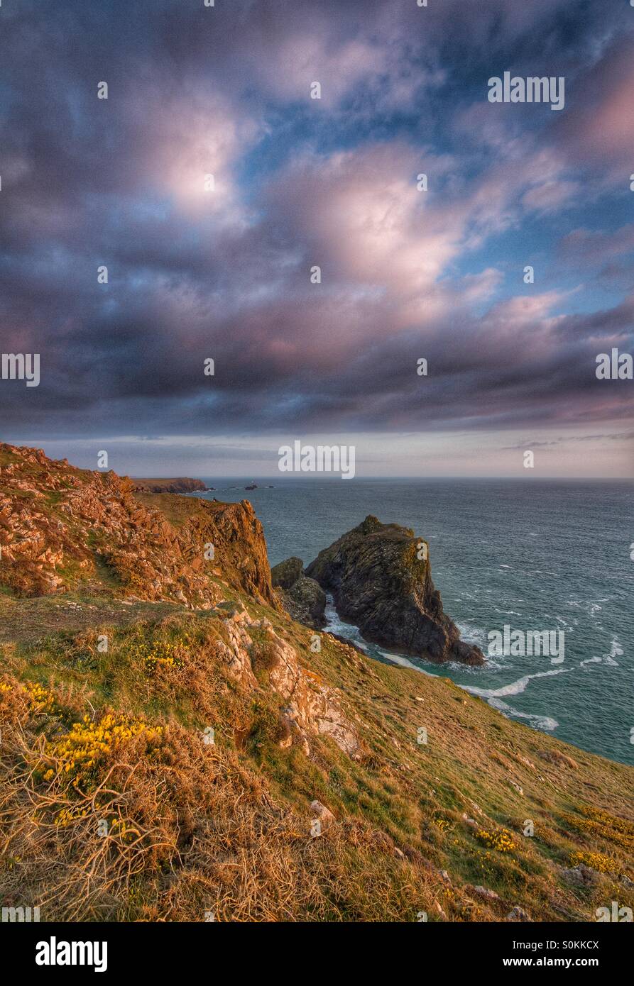 A Coastal landscape of a green ocean, tall cliffs and sunlit clouds. - Smartphone Captured Stock Image