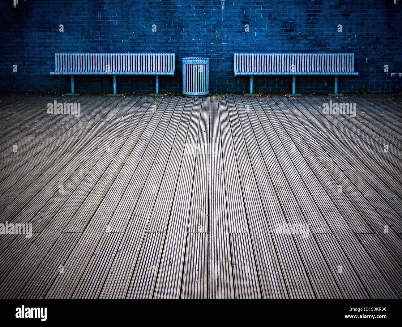 Metal public seating benches with aa dustbin and wooden decking, near Glasgow - Smartphone Captured Stock Image