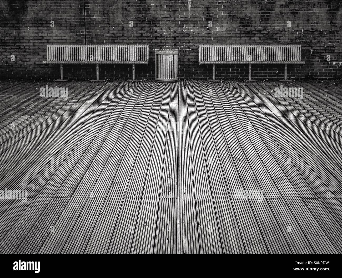 Metal public seating benches with aa dustbin and wooden decking, near Glasgow - Smartphone Captured Stock Image