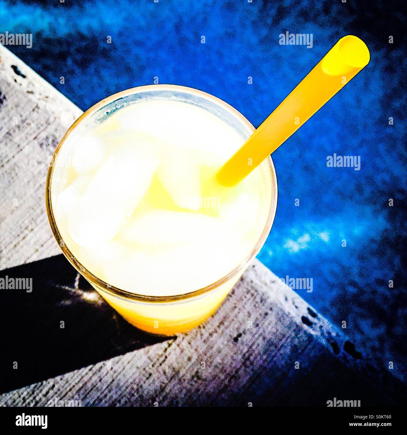 Poolside drink in the sun. Bright edit. - Smartphone Captured Stock Image