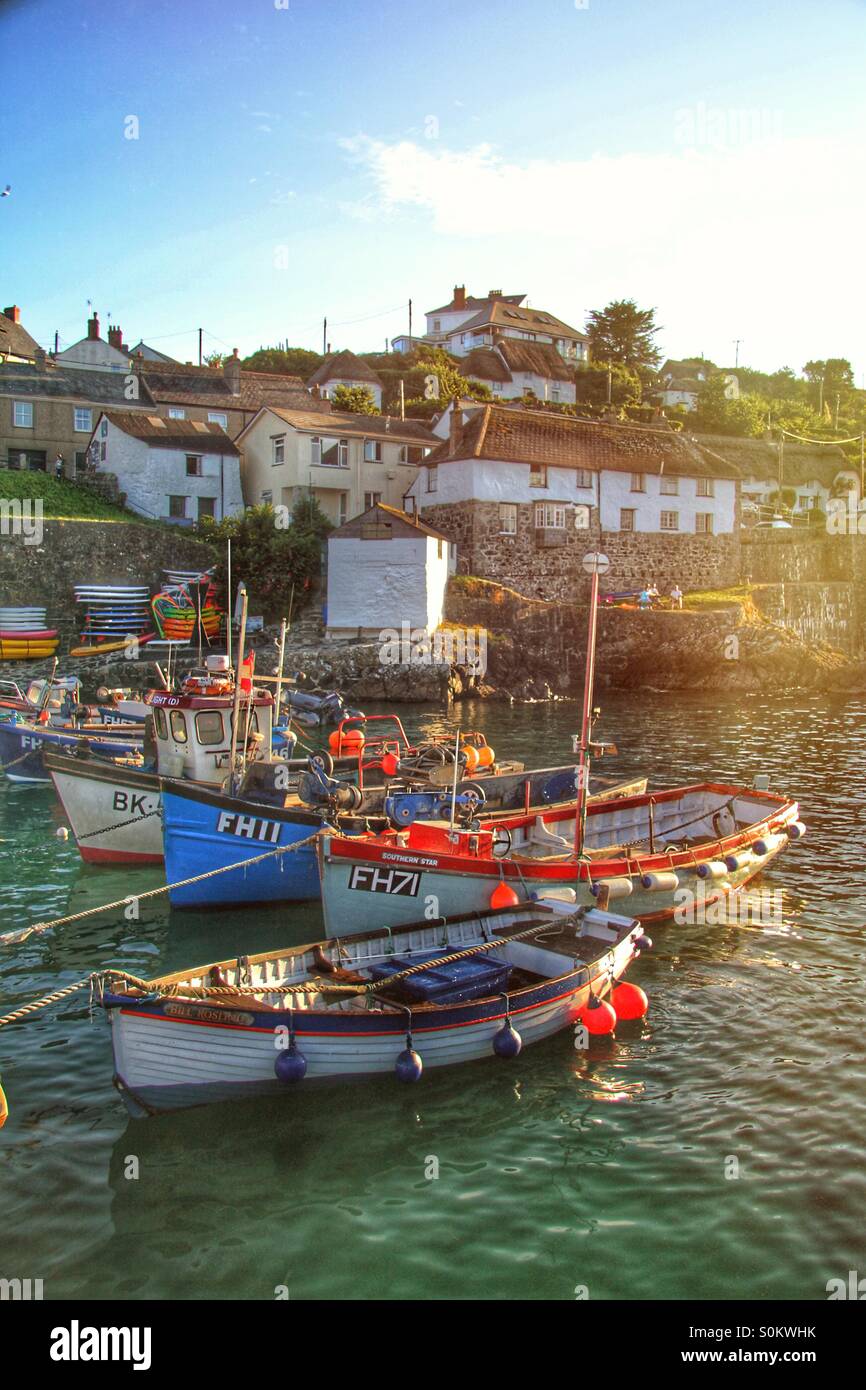 A harbour full of fishing boats in a quaint Cornish harbour at sunset. - Smartphone Captured Stock Image