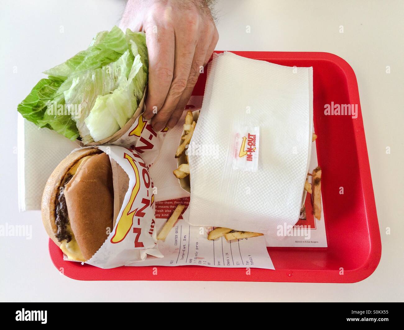 Man reaches for a gluten free version of a hamburger at In-N-Out Burger in California, USA - Smartphone Captured Stock Image