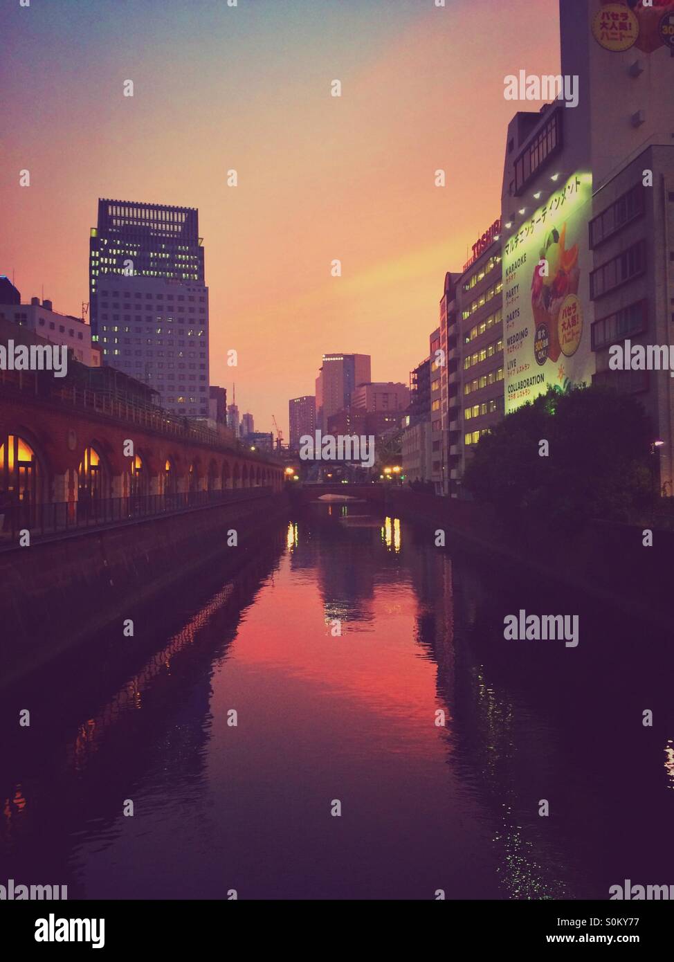 Sunset with city reflections on the water - Akihabara, Japan Stock Photo