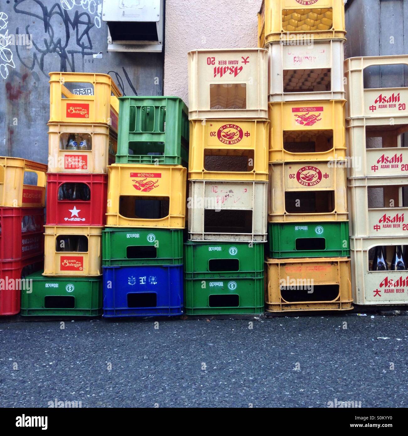 Colourful empty beer crates stacked outside a bar in Tokyo Stock Photo