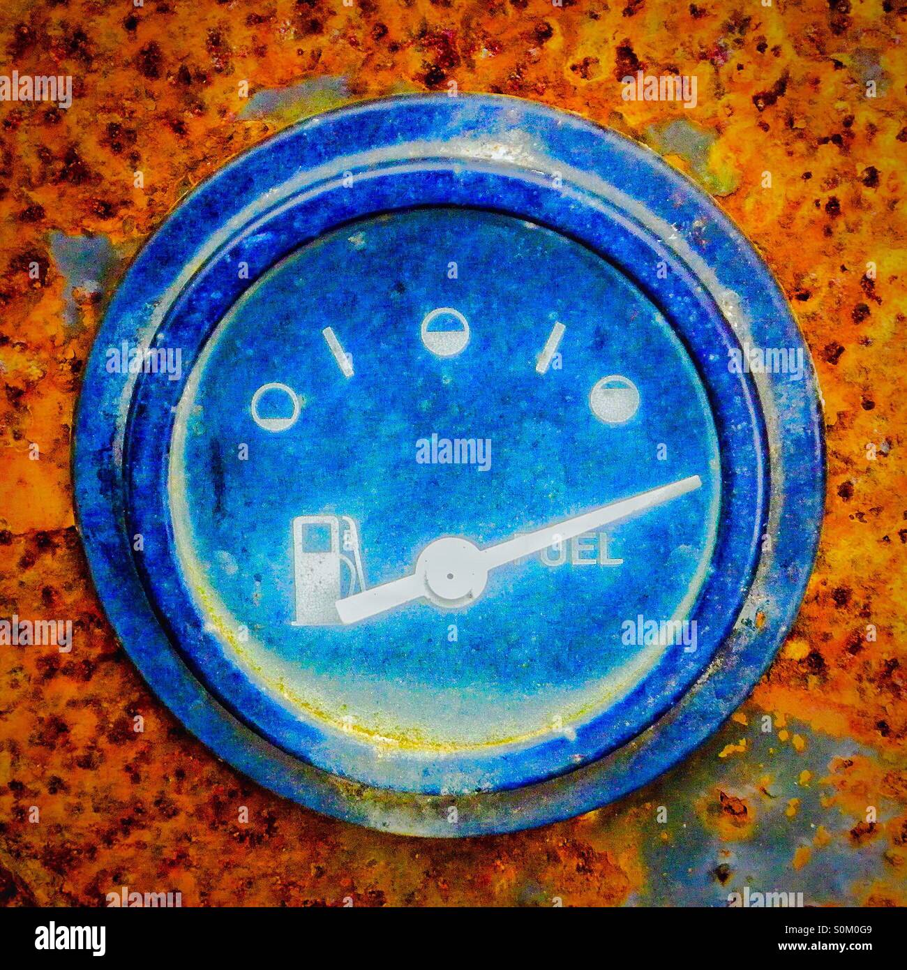 Blue coloured fuel gauge shown full, on an old rusty - Smartphone Captured Stock Image
