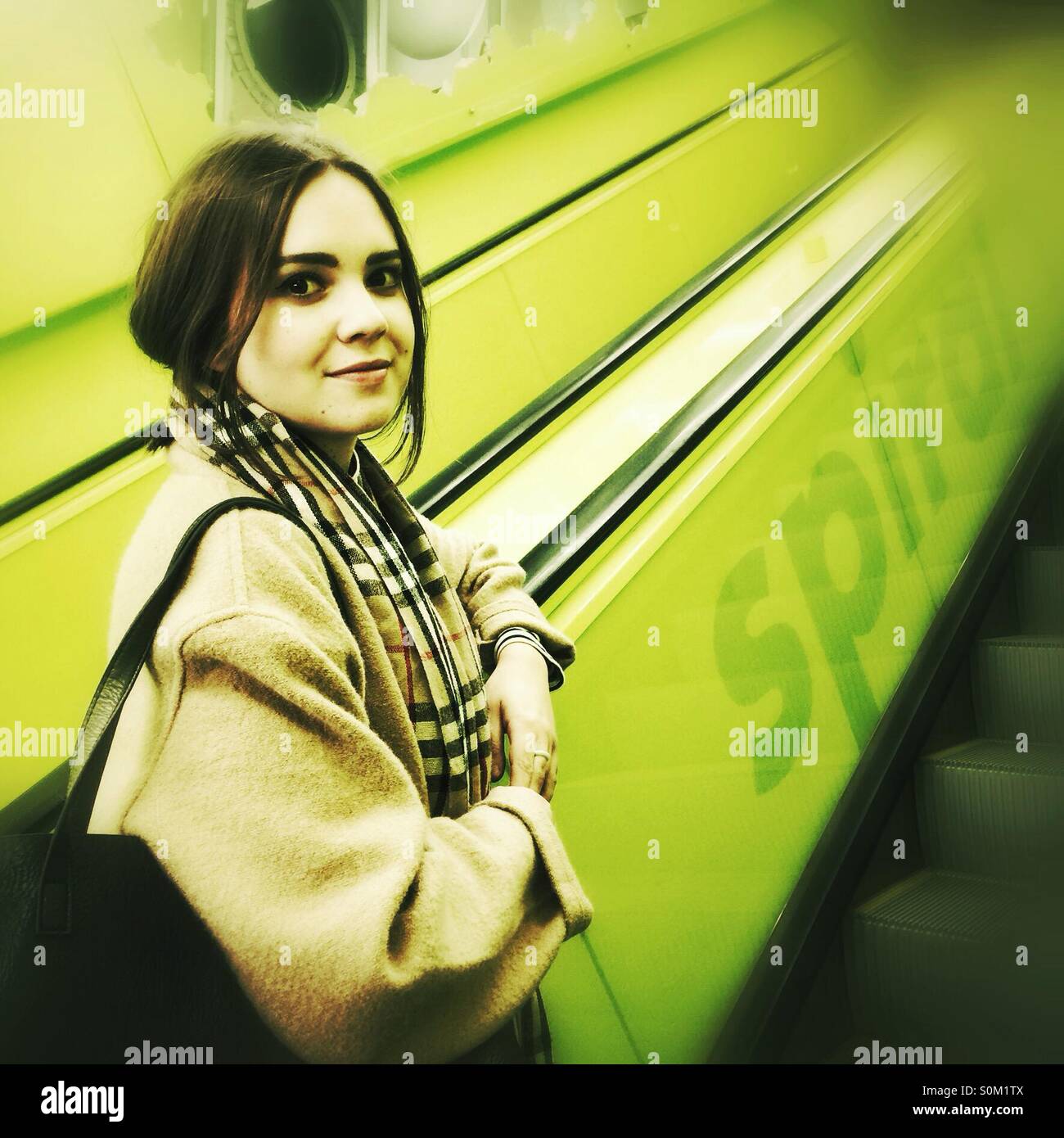young woman on the escalator in Seattle central public library - Smartphone Captured Stock Image