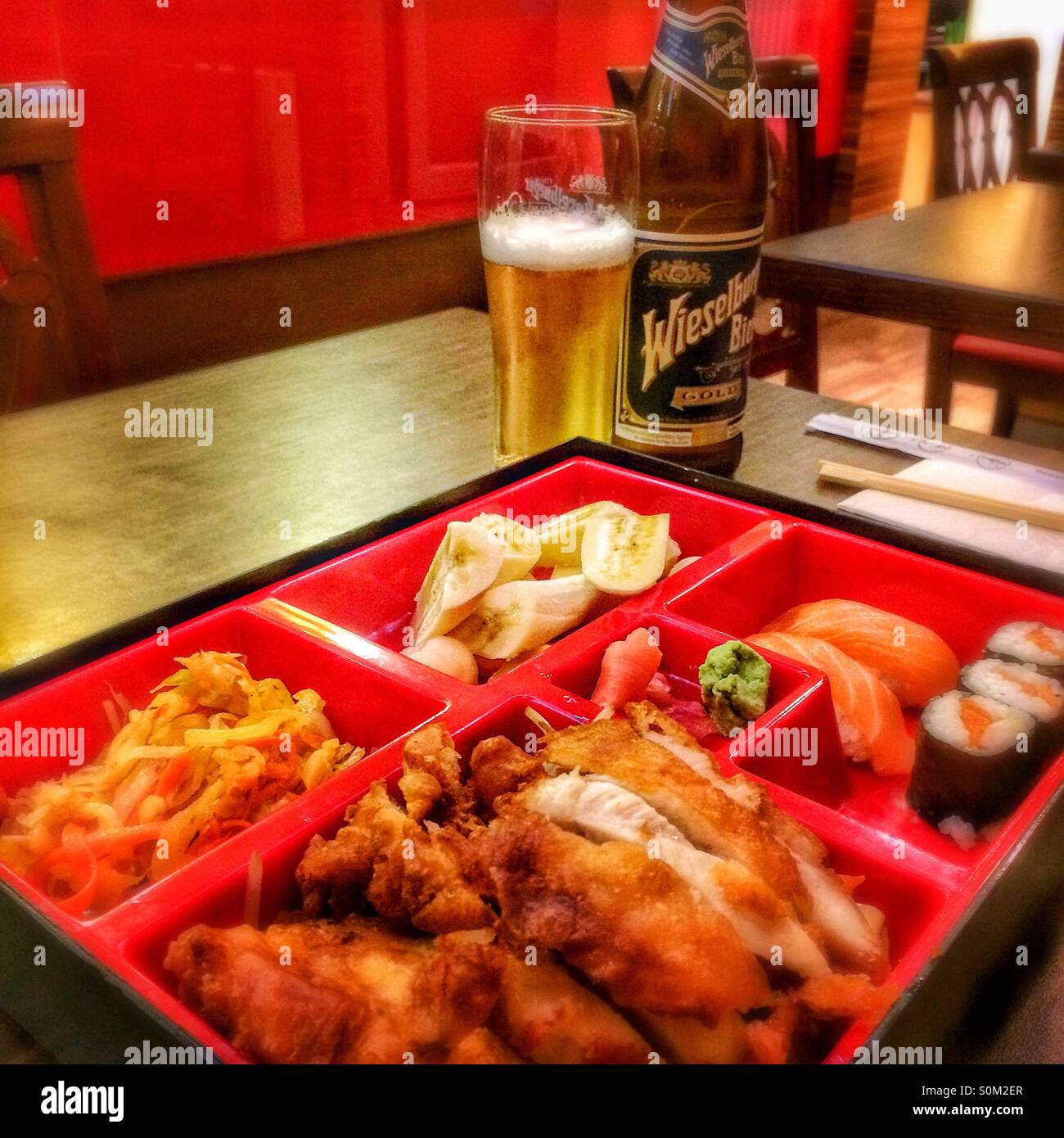 Japanese bento box dinner with beer in Vienna, Austria - Smartphone Captured Stock Image