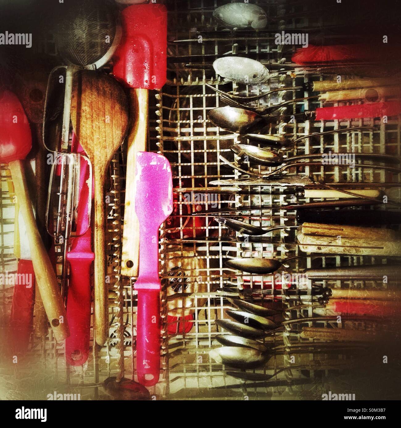 Utensils in dishwasher Stock Photo