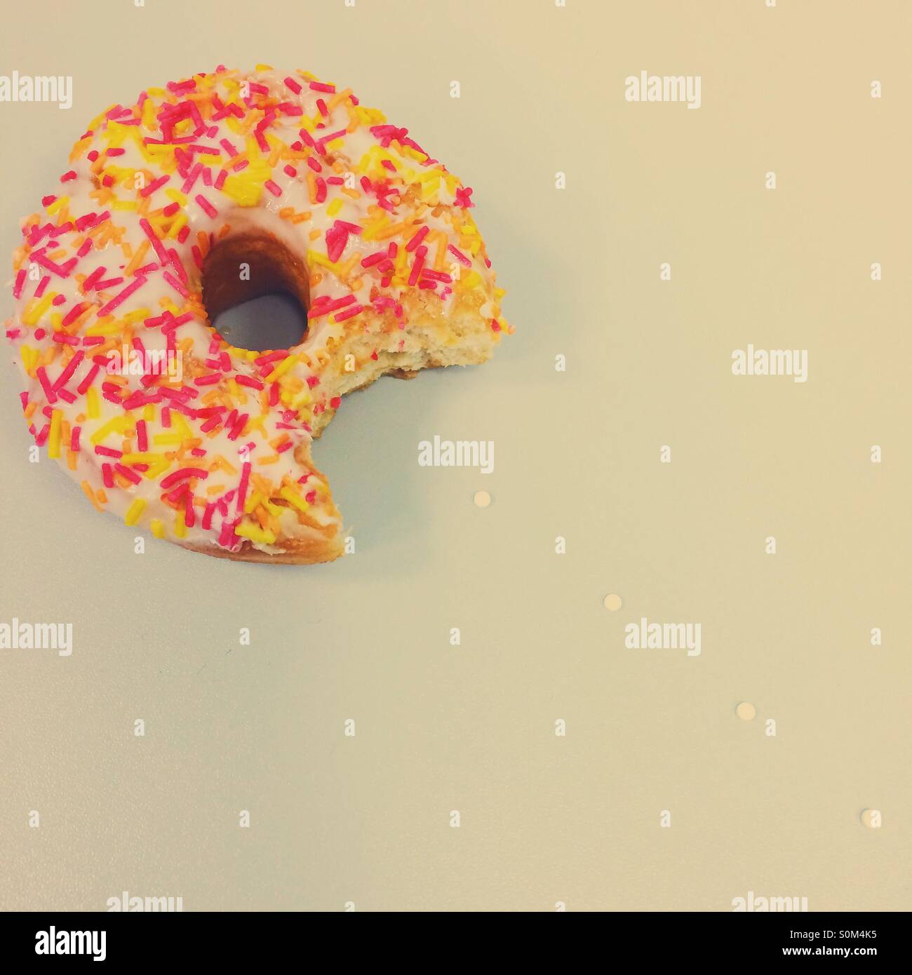 Ring doughnut with bite taken out of it - Smartphone Captured Stock Image