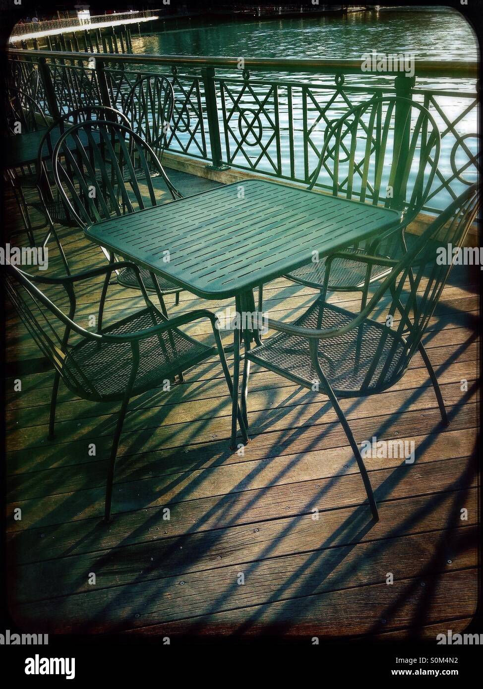 Empty table and chairs by lake - Smartphone Captured Stock Image