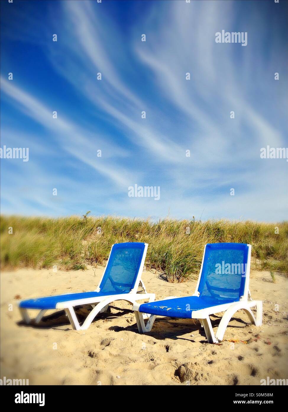 Two blue beach chairs in the dunes Stock Photo Alamy
