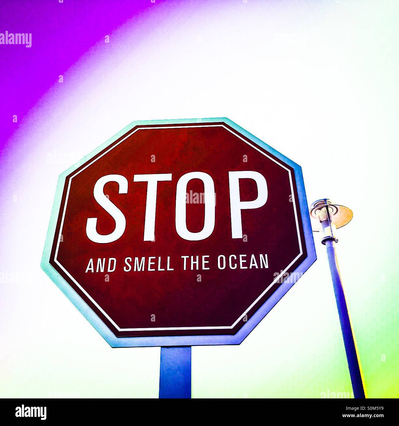 Sign in Ventura, California reads 'Stop and smell the ocean' - Smartphone Captured Stock Image