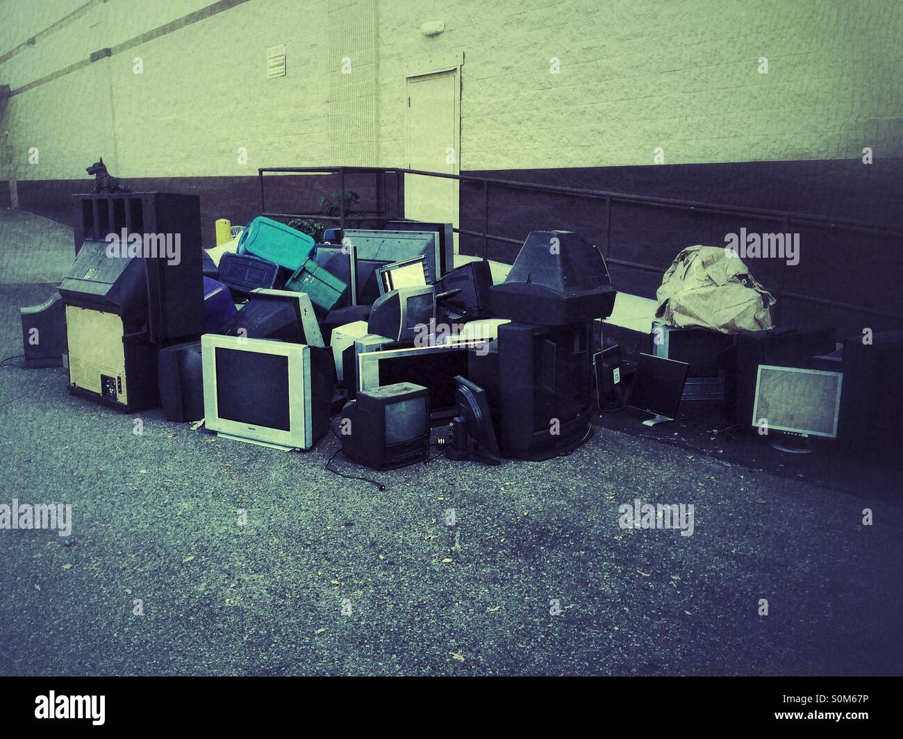 Old TVs and monitors next to a building - Smartphone Captured Stock Image
