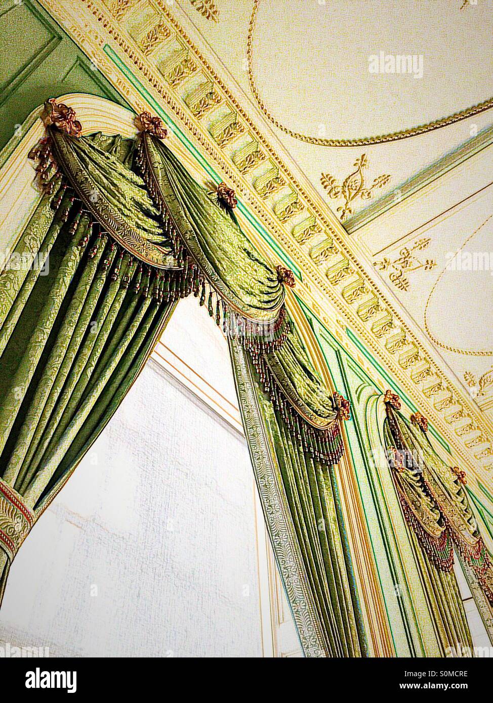 Ornamental vintage draperies hang in a majestic manner. Stock Photo