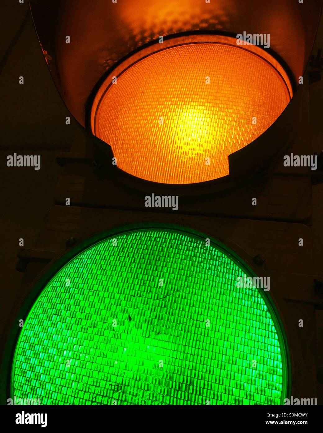 Close-up of illuminated amber yellow and green traffic signals. - Smartphone Captured Stock Image Close-up of illuminated amber yellow and green traffic signals. - Smartphone Captured Stock Image