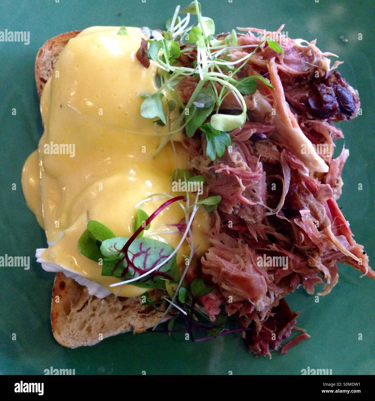 Modern eggs Benedict with ham hock and greens Stock Photo