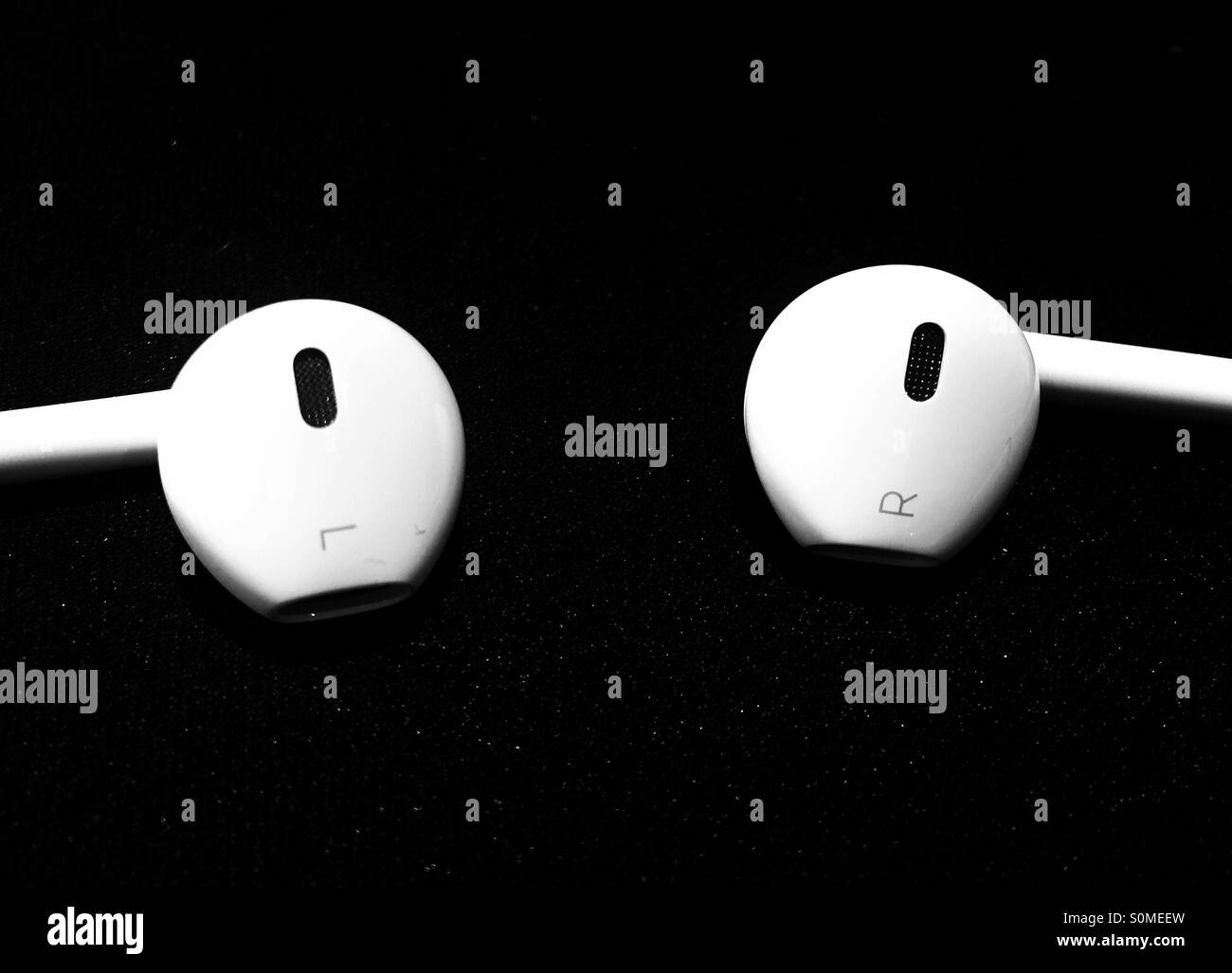 Right and left in-ear headphones. - Smartphone Captured Stock Image