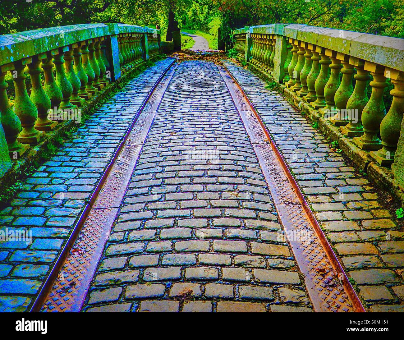 Cobbled bridge and coach wheel guides, Pollok Country Park, Glasgow, Scotland. - Smartphone Captured Stock Image