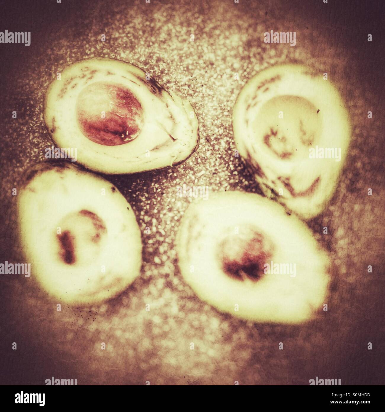 Two overripe avocados cut in half - Smartphone Captured Stock Image