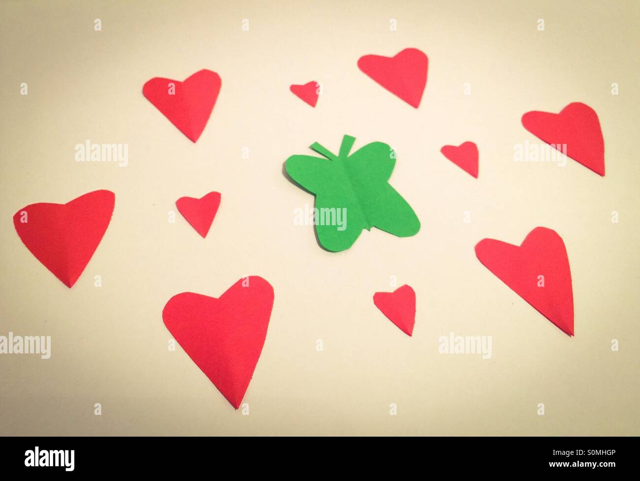 Butterfly and heart shape paper cut outs - Smartphone Captured Stock Image