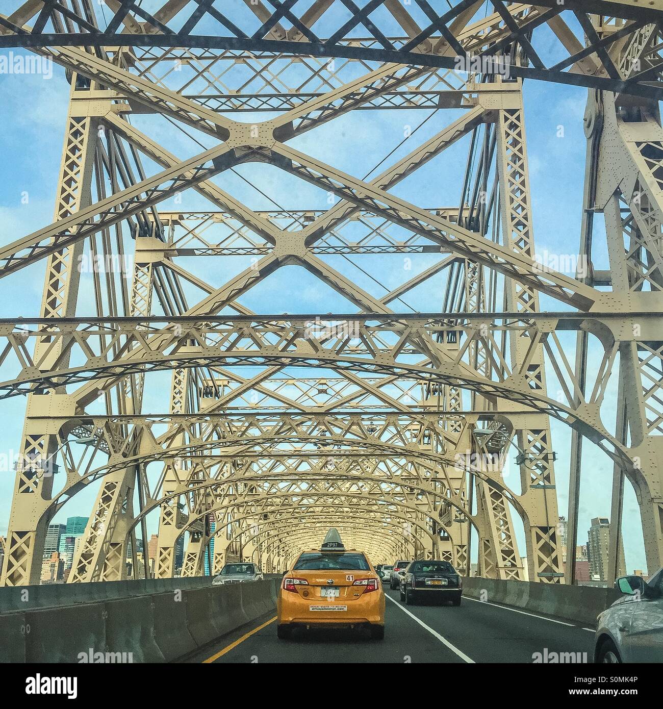 New York City taxi driving over the Queens bridge. Stock Photo