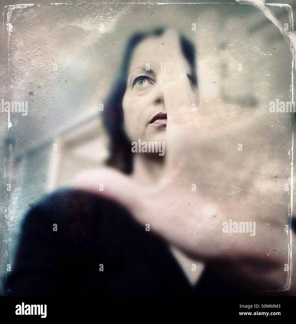 Woman with hand in front of her face - Smartphone Captured Stock Image