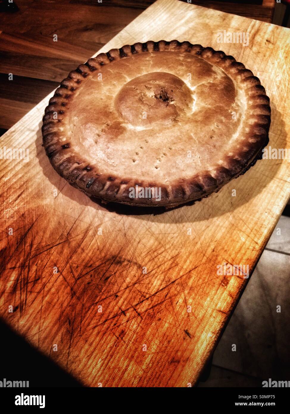 Crusty pie on chopping board - Smartphone Captured Stock Image