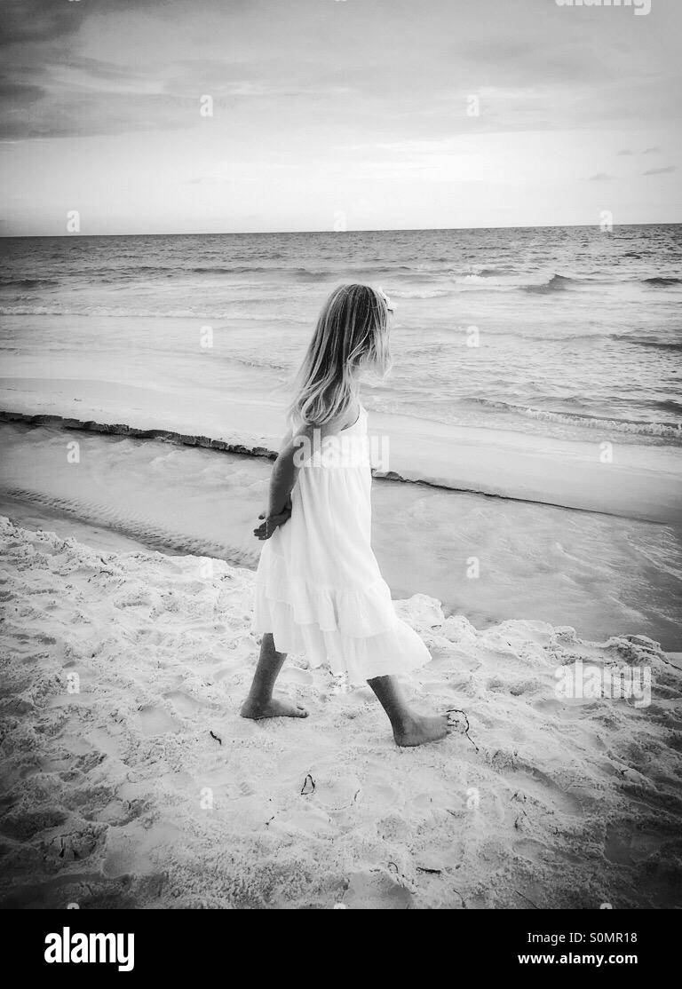 Little girl walking on the beach Stock Photo