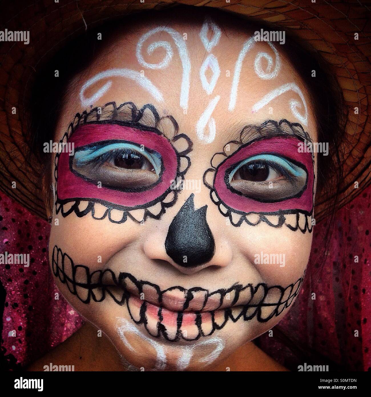 A young Catrina smiles in Mexico City. The Day of the Dead celebration mixes Pre-Hispanic traditions with the European tradition of the Catholic All Souls Day. Stock Photo