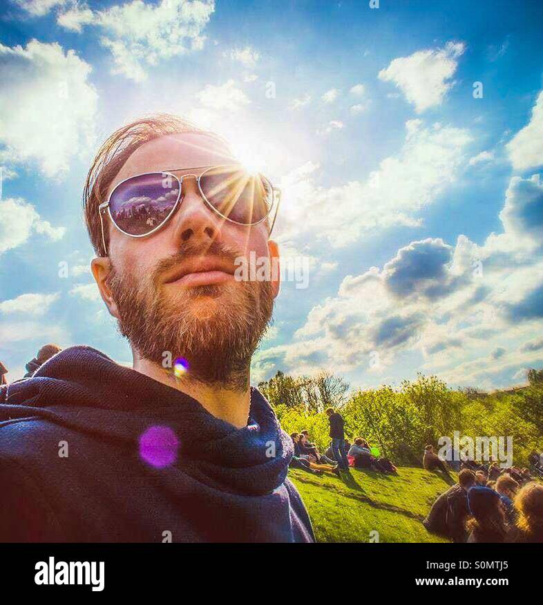 Guy with sunglasses in park Stock Photo Alamy
