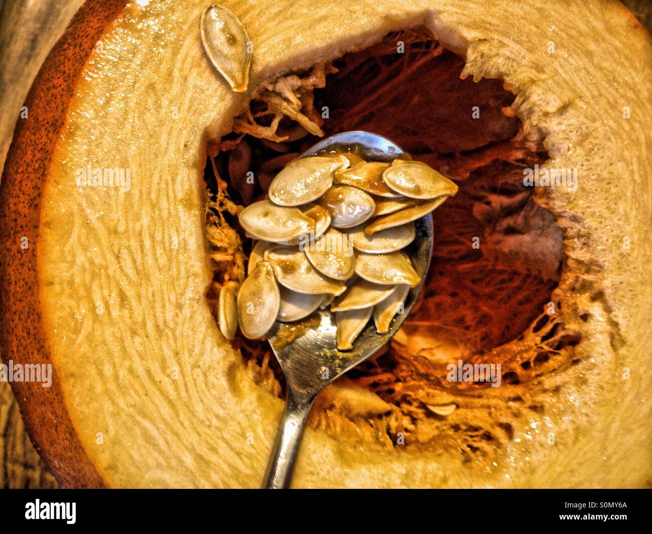 Taking seeds out of a pumpkin - Smartphone Captured Stock Image