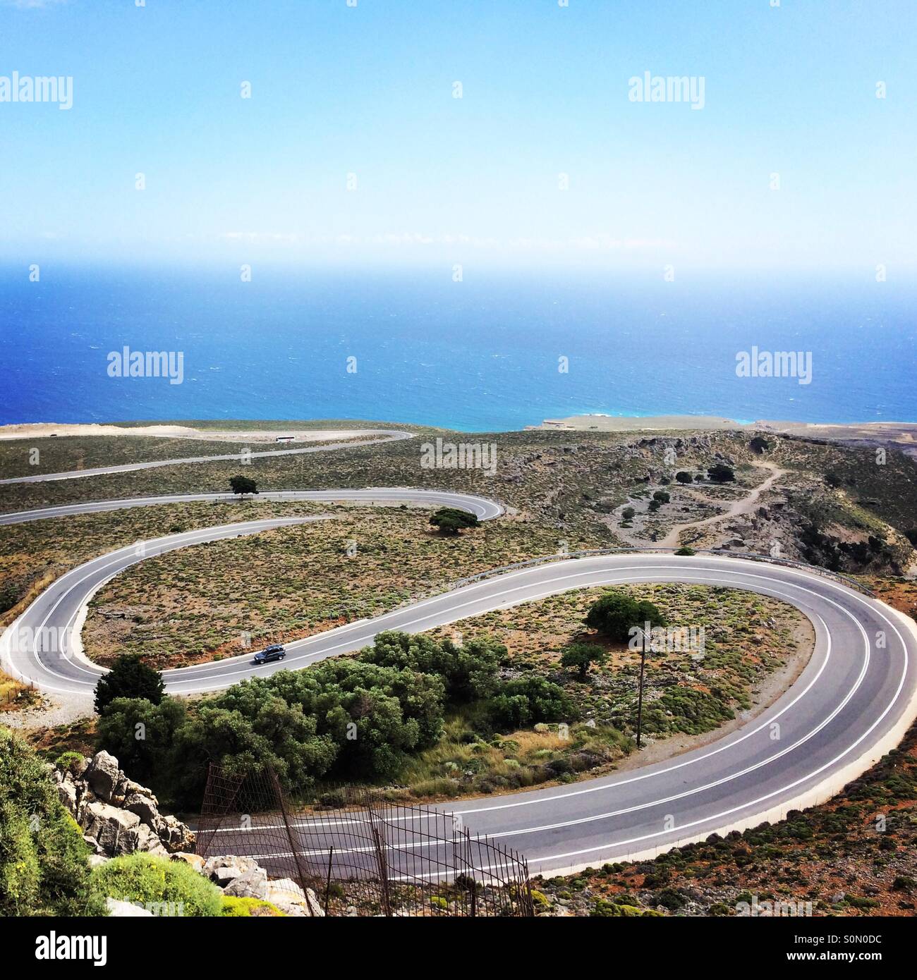 Steep road curves on the way to the remote and wild region of Sfakia, in southern Crete, Greece, Europe - Smartphone Captured Stock Image