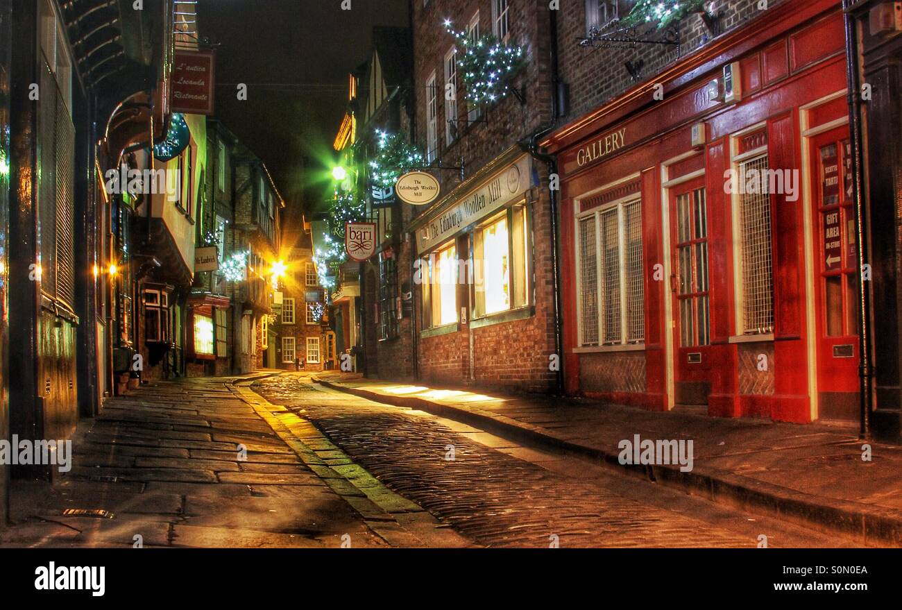 A medieval street in York called The Shambles at night. Lit by colourful artificial lights at night. - Smartphone Captured Stock Image