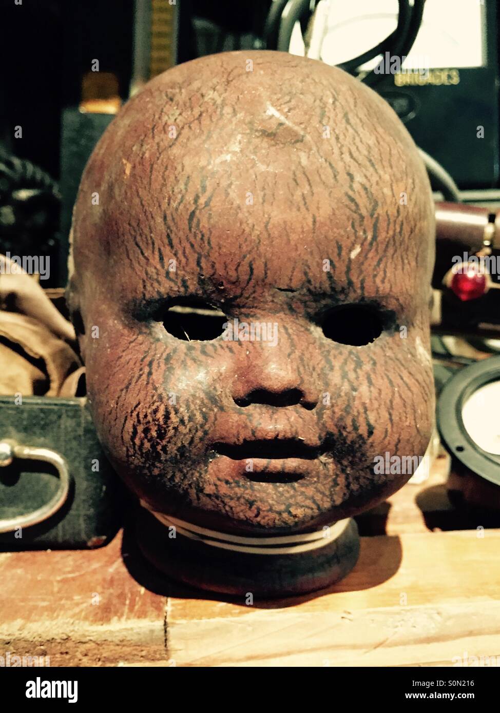Antique baby dolls head in a junk shop Stock Photo