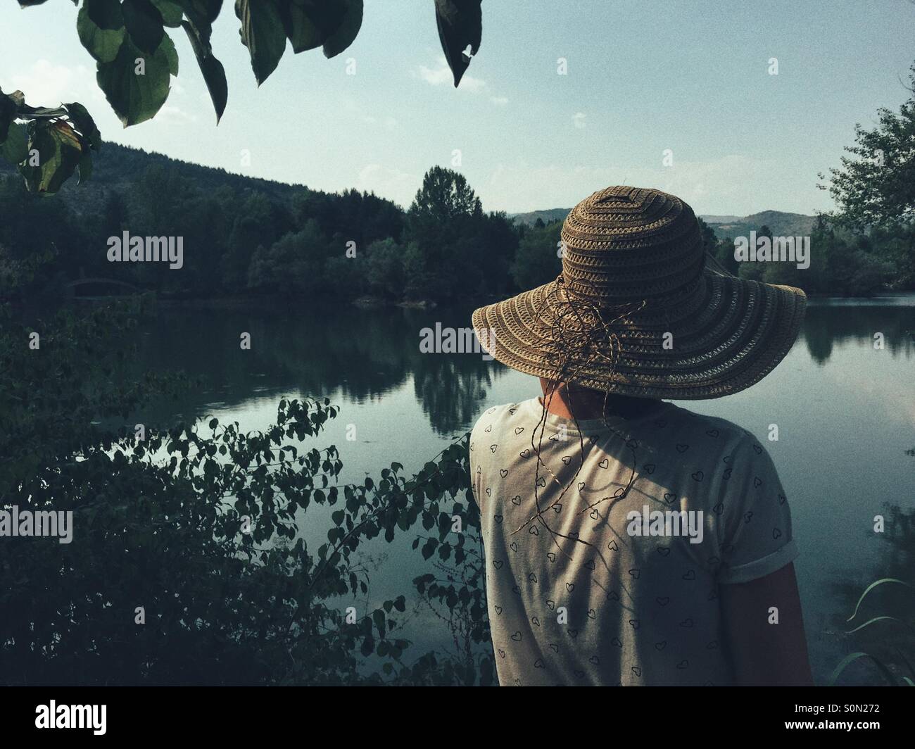 Rear view of Woman looking across lake - Smartphone Captured Stock Image