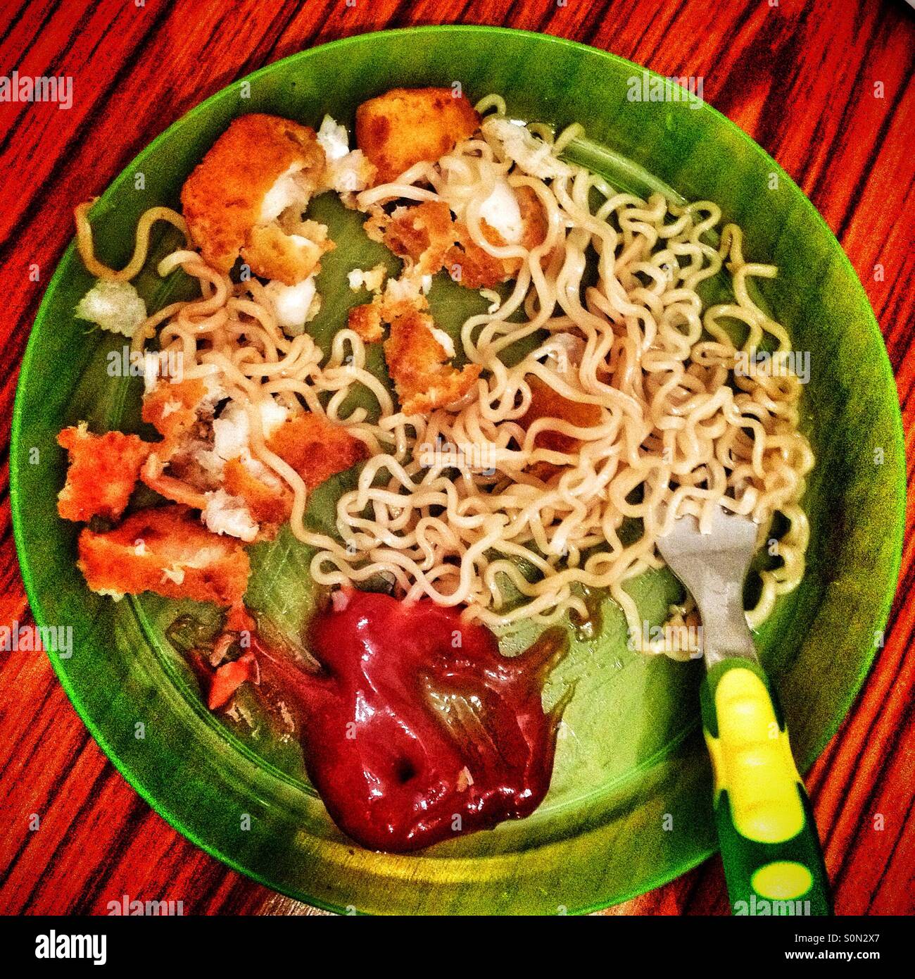 A child's half eaten plate of food. - Smartphone Captured Stock Image