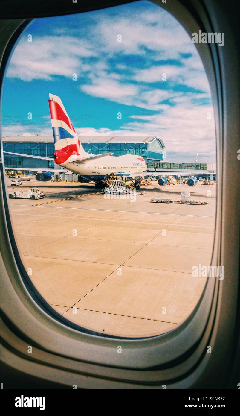 A view of a British Airways Boeing 747 aircraft through an aircraft window Stock Photo