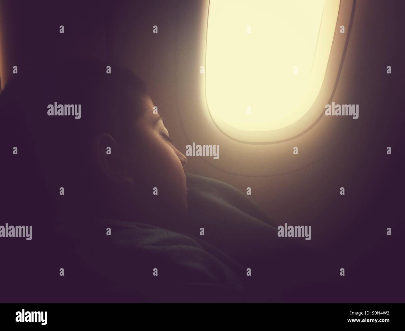 Little boy sleeping in airplane Stock Photo