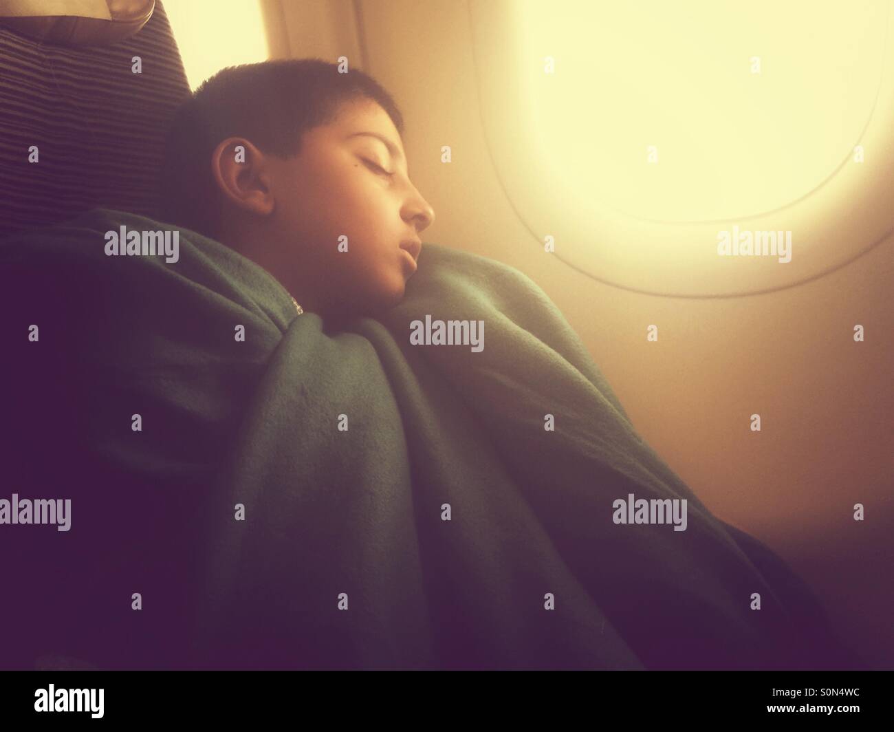 Boy sleeping on the plane - Smartphone Captured Stock Image