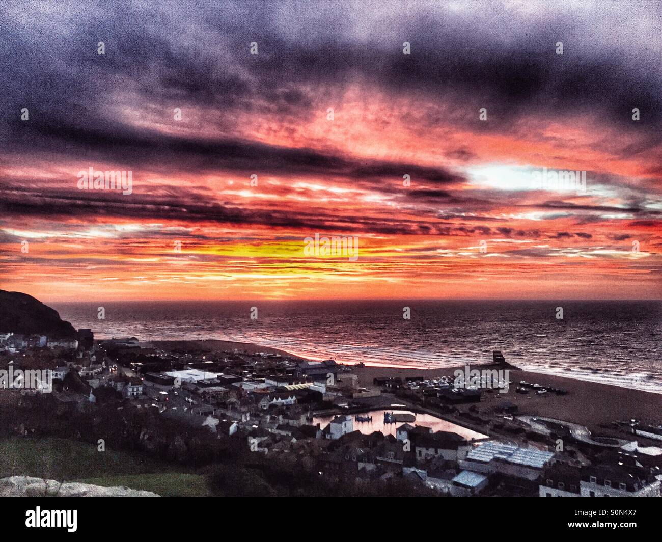 Dramatic sunrise over the sea at Hastings, East Sussex, England, UK - Smartphone Captured Stock Image