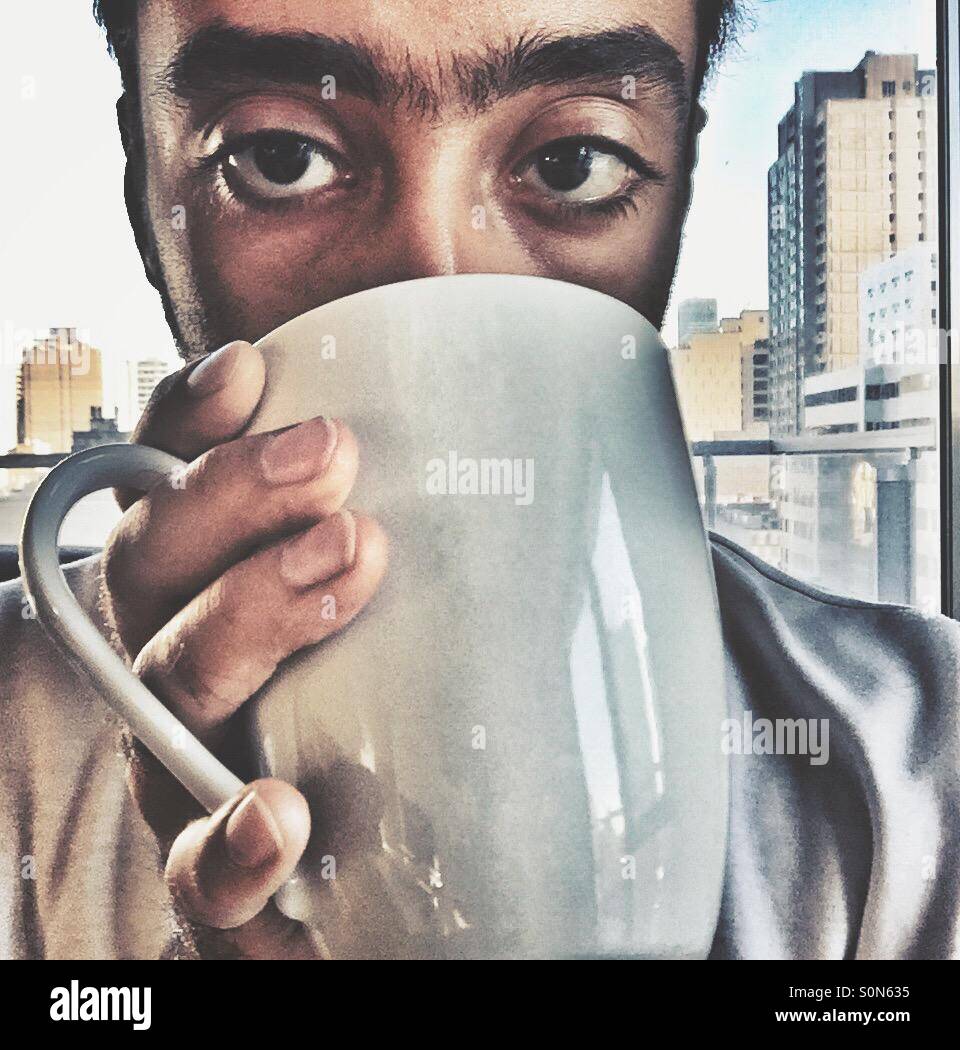 A guy drinking coffee Stock Photo Alamy