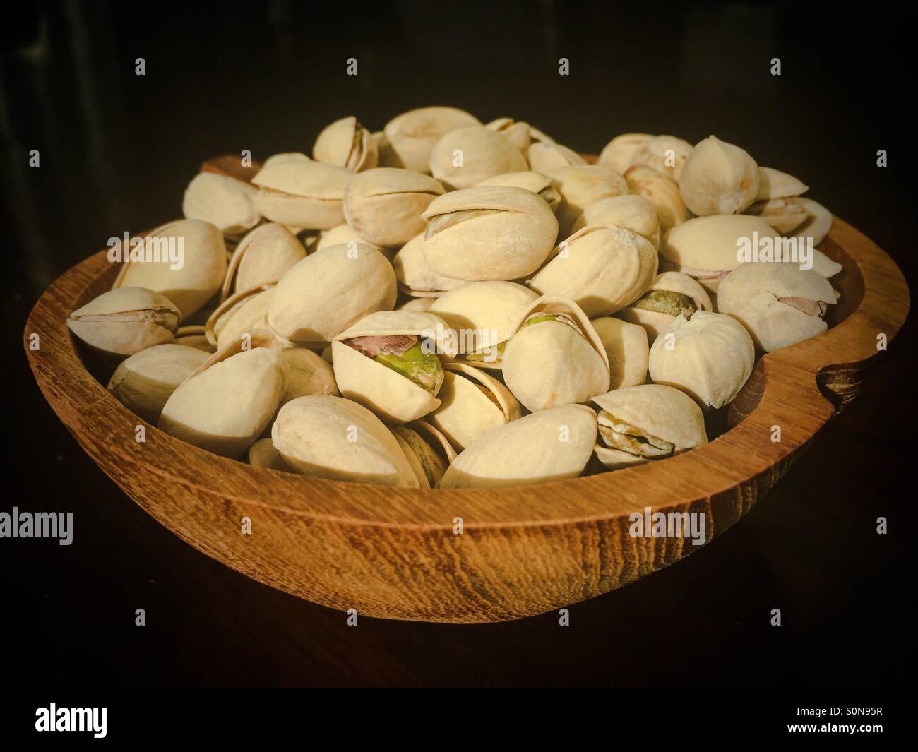Pistachios in a wooden bowl. - Smartphone Captured Stock Image