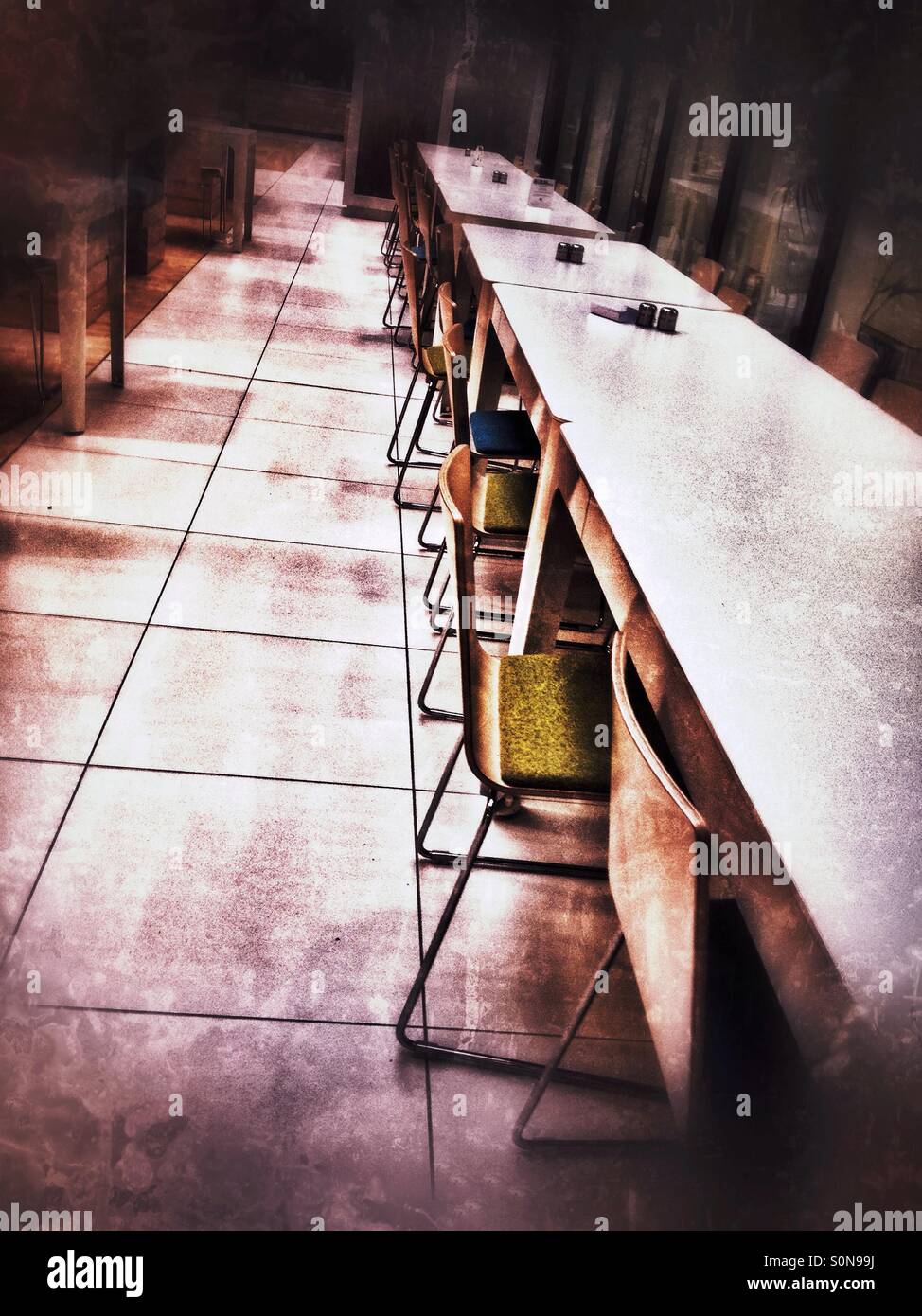 Tables and chairs in the work canteen. - Smartphone Captured Stock Image