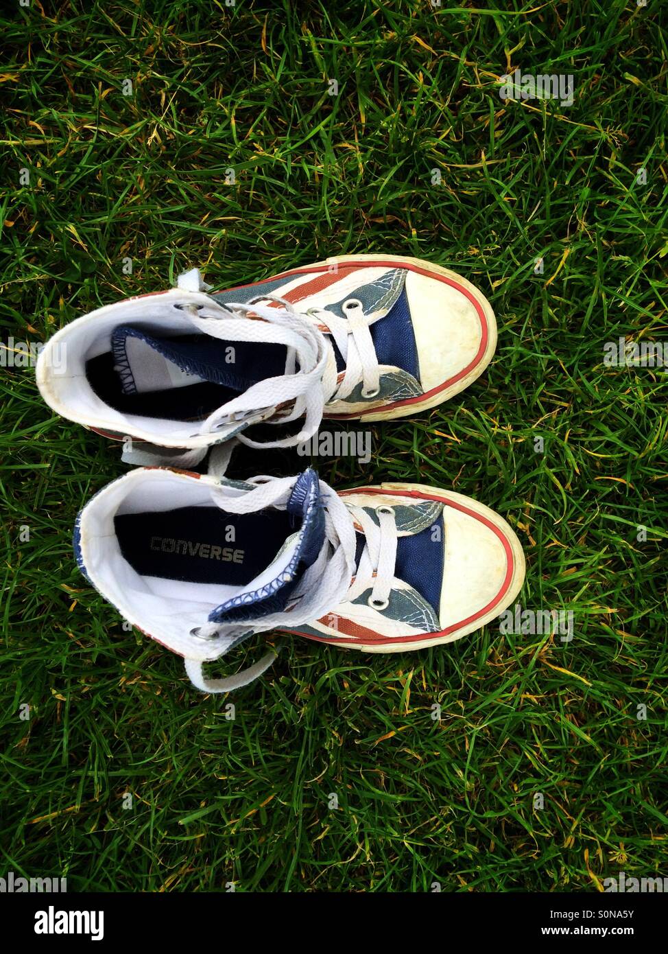 Looking down on a pair of kid's basketball boots in Union Jack flag colours - Smartphone Captured Stock Image