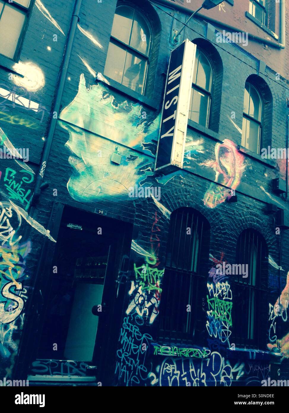 Hosier Lane street art in Melbourne of girls face at Misty Bar - Smartphone Captured Stock Image