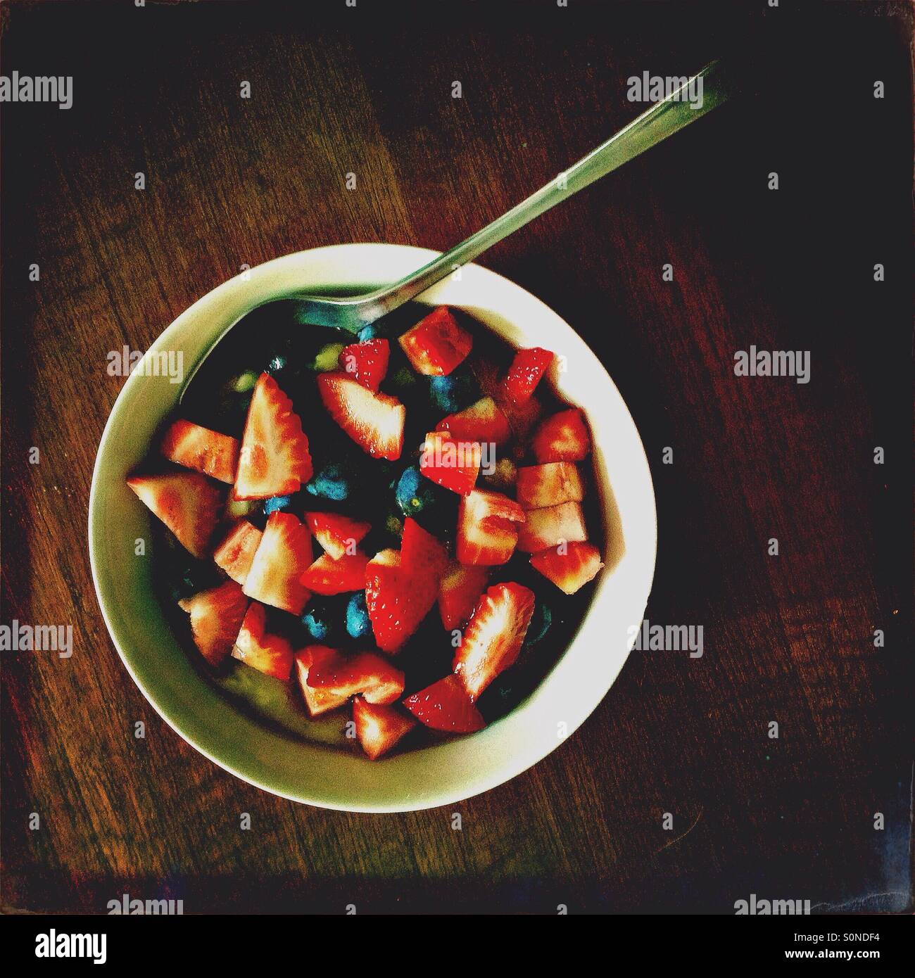 Bowl of breakfast porridge with strawberries and blueberries - Smartphone Captured Stock Image