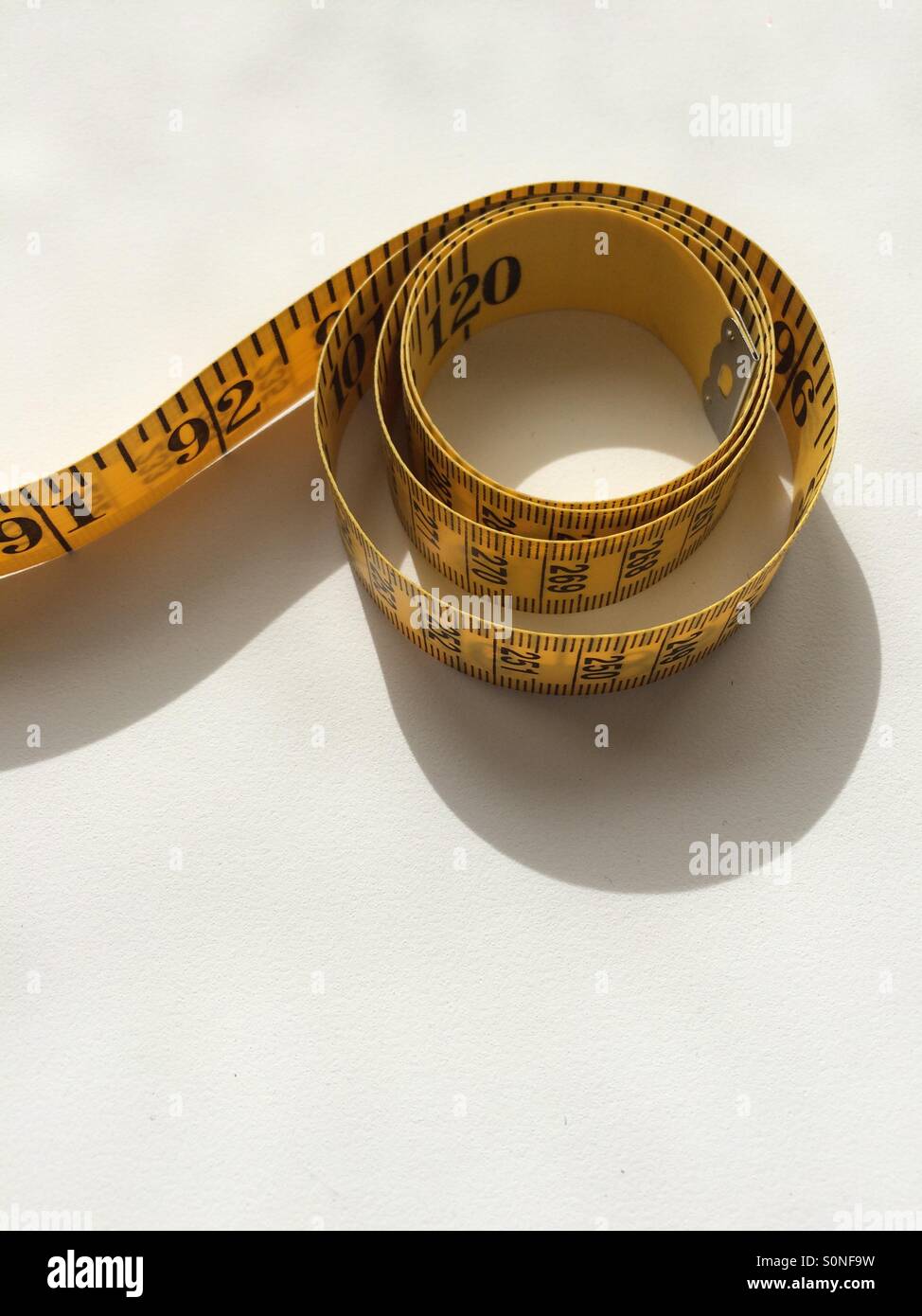 Rolled up red tape measure hi-res stock photography and images - Alamy