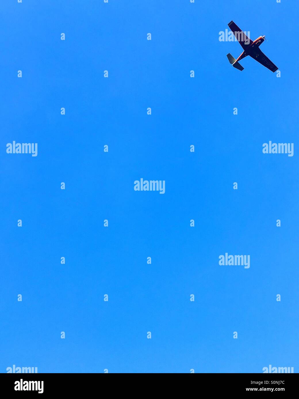 Minimalist plane on blue sky - Smartphone Captured Stock Image