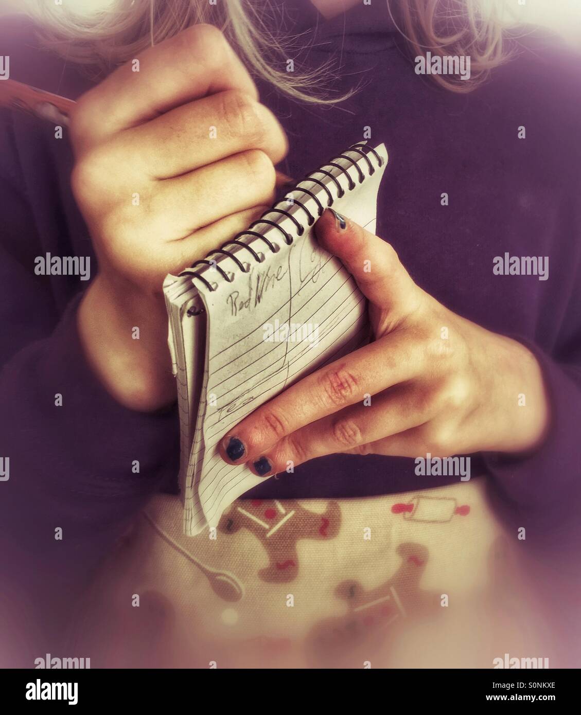 Young girl pretending to be a waitress and taking an order Stock Photo