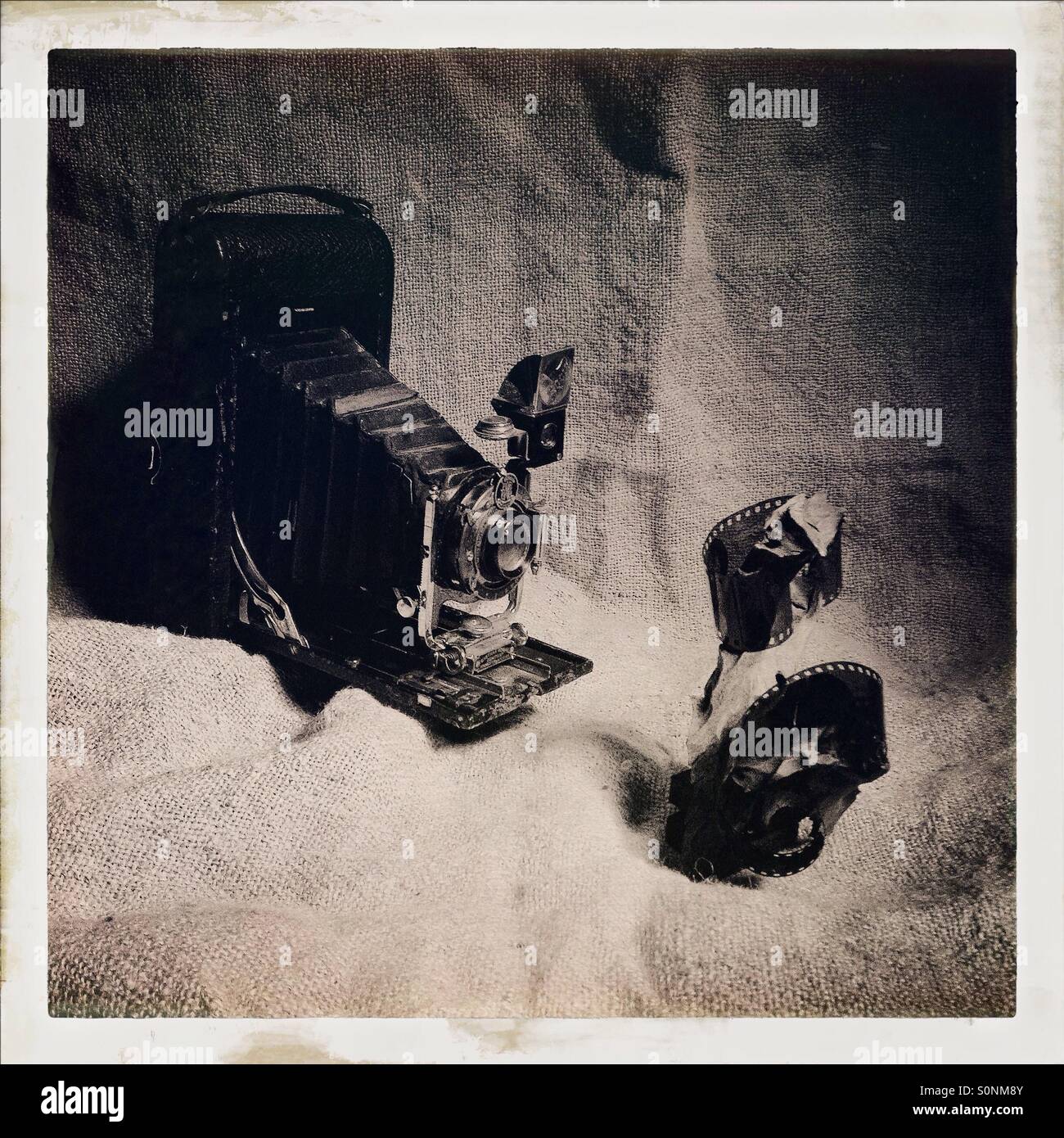 Vintage photography themed image , old style bellows folding camera - Smartphone Captured Stock Image